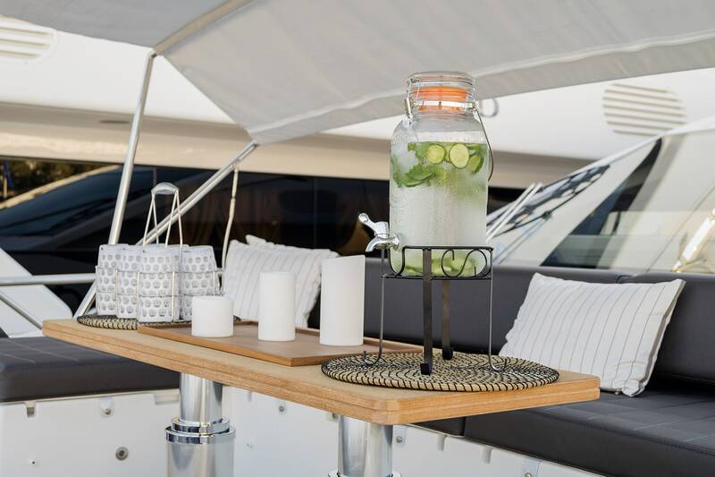 Seating area on bow with teak coffee table and Bimini top
